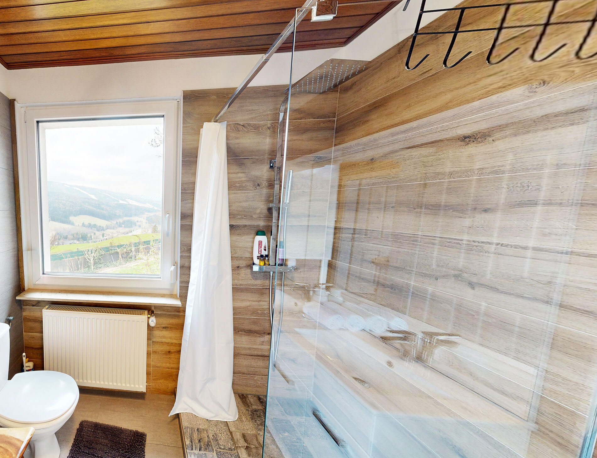 An en-suite bathroom with a window onto the valley.