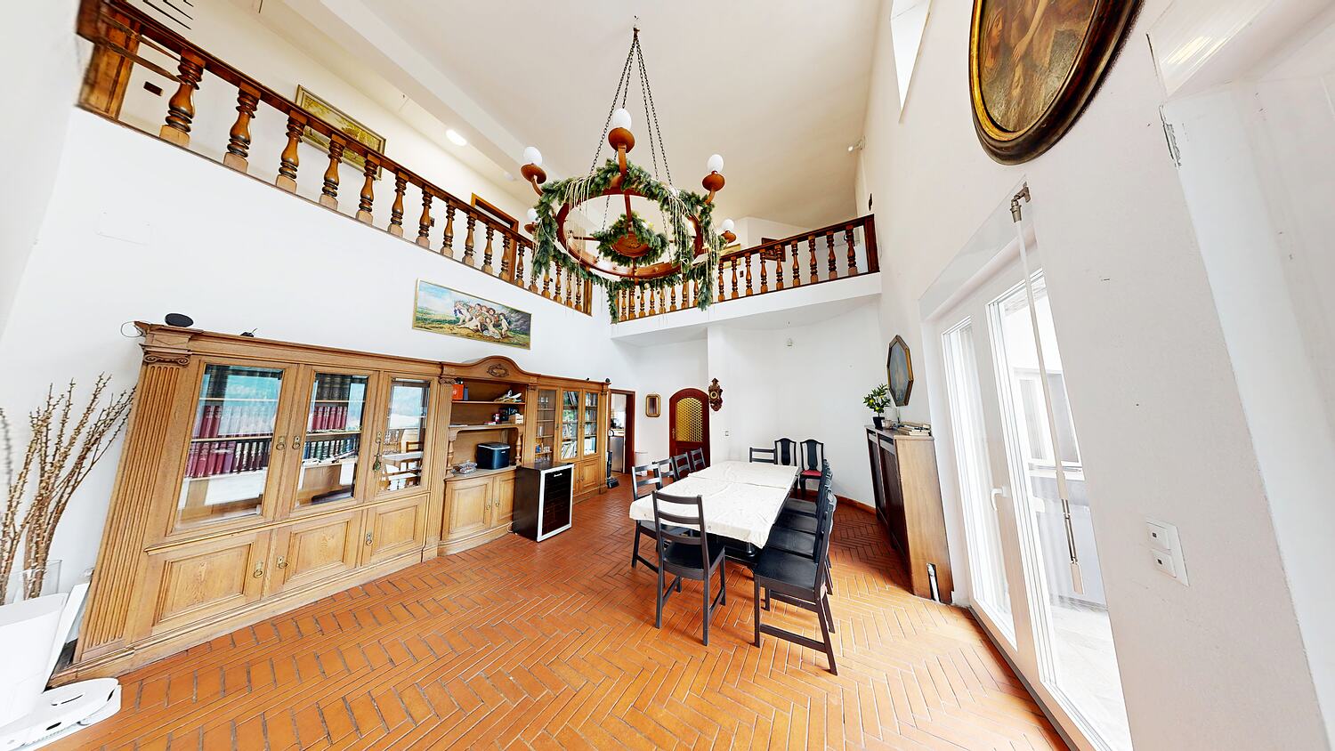 The hall seen from its other end, gallery above, bookcase along the wall.