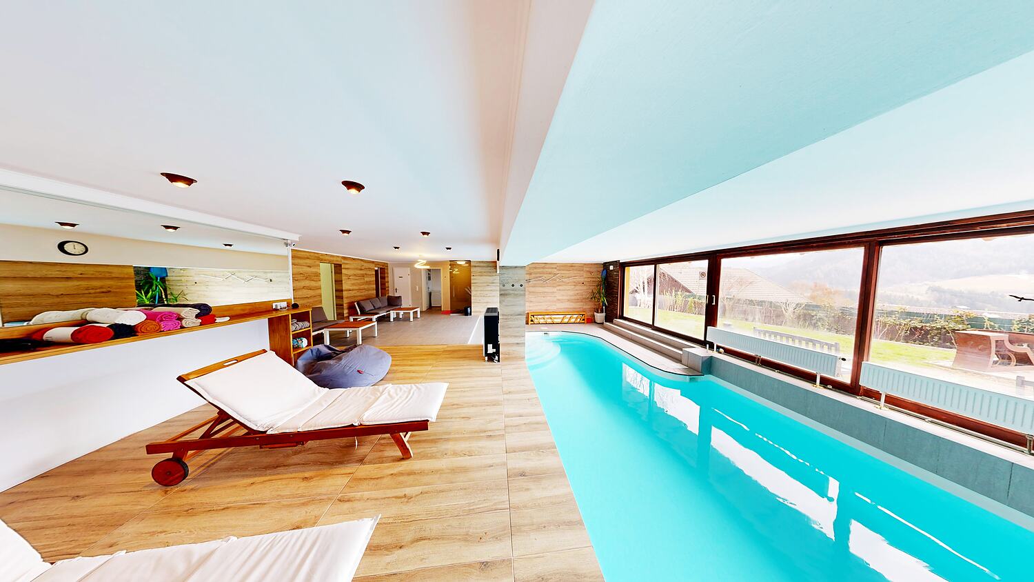 Pool with loungers and relaxation area.