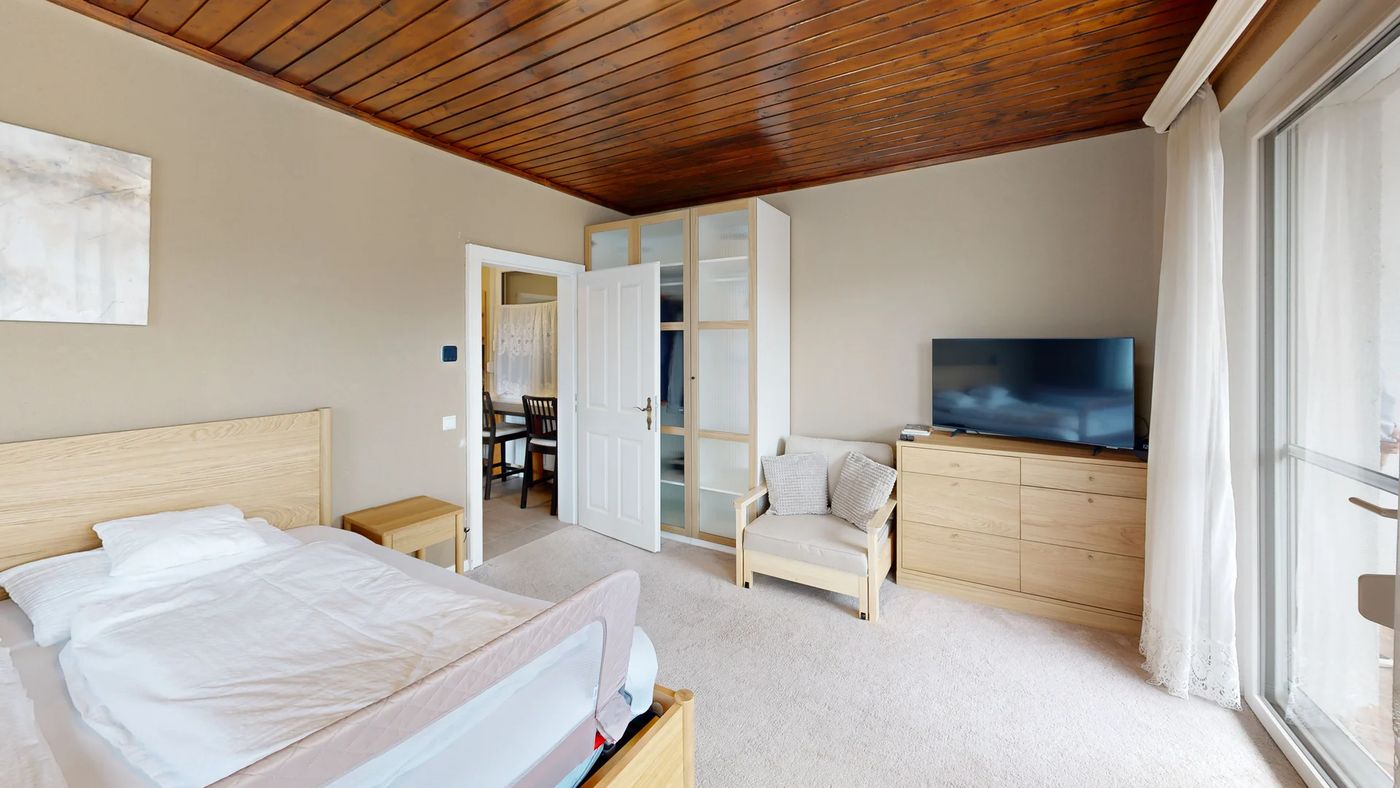 Room 4 — pale oak furniture, carpet and a pine ceiling.